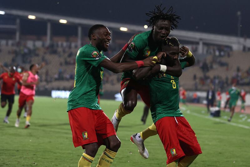 Cameroon forward Karl Toko Ekambi, left, celebrates with teammates after their penalty shootout victory against Burkina Faso in the Africa Cup of Nations in February 2022. AFP