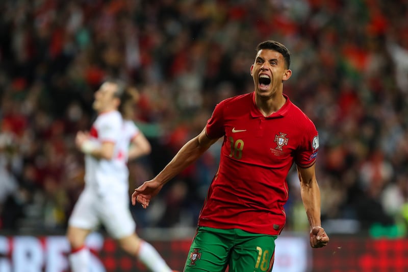 Matheus Nunes celebrates after scoring Portugal's third in injury time. EPA