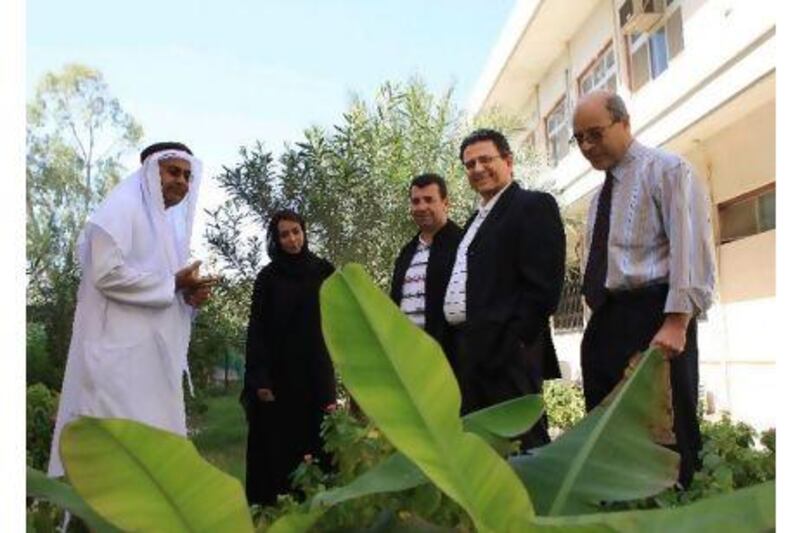 Mohammed S. Gheblawi, (second right), chair of the Department of Agribusiness and Consumer Sciences at Faculty of Food and Agriculture with Professor Ghaleb al Hadrami (left) Dean Faculty of Food and Agriculture along with other collegues at UAE University campus in Al Ain. Ravindranath K / The National