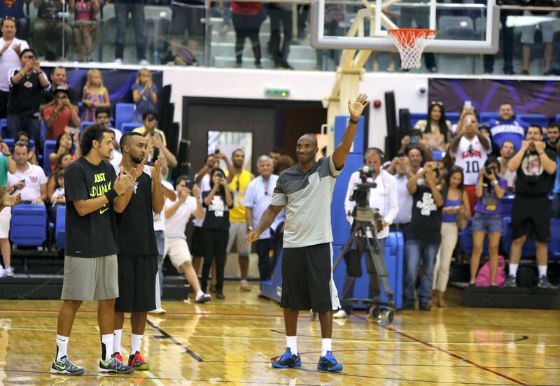 LA Lakers NBA player Kobe Bryant salutes the crowd as he arrives to American University of Dubai basketball court to coach a team made up of local celebrities on  September, 27, 2013.  Bryant arrived for a Health and Fitness Weekend, to promote awareness of diabetes in the United Arab Emirates in his first trip to a Middle East country. AFP PHOTO/MARWAN NAAMANI (Photo by MARWAN NAAMANI / AFP)