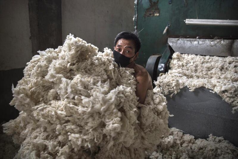 A worker gathers up imported sheep’s wool after it was processed and bleached at a factory near Zhangzhou. China is the major market for Australian wool, with more than 75 per cent of Ausralia's wool clip output exported to China for processing. Kevin Frayer / Getty Images