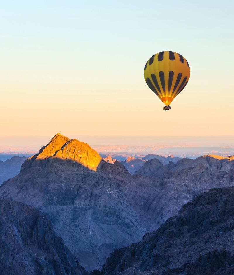 Hot air balloon over Mount Moses Sinai on sunset, Sinai desert Egypt