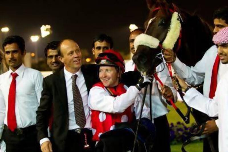 Trainer Ernst Oertel, centre left, and jockey Tadhg O'Shea have found many successes at the Abu Dhabi Equestrian Club this season.