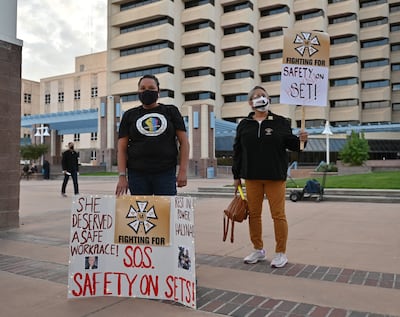 Attendees hold signs calling for better safety on movie sets during a vigil held to honour cinematographer Halyna Hutchins. AFP
