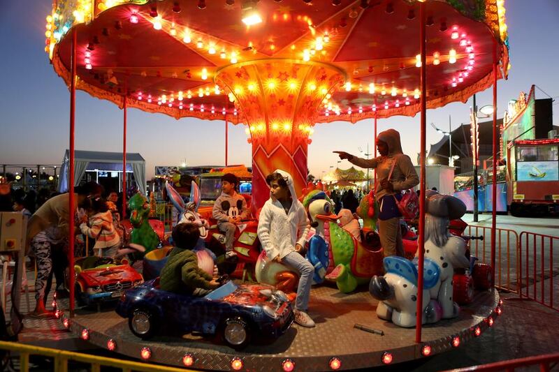 Children enjoy rides at the Six Continents Festival at Khalifa Park in Abu Dhabi yesterday. Sammy Dallal / The National 