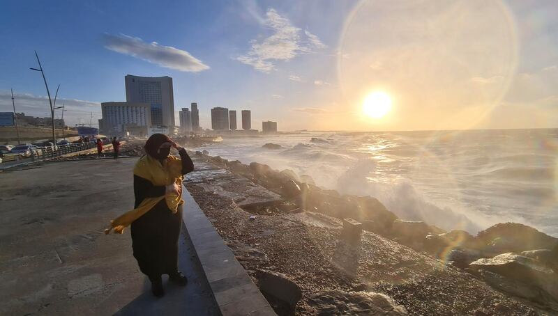 A Libyan woman stands on the shore of the Mediterranean Sea in the capital Tripoli on January 26, 2021. / AFP / Mahmud TURKIA
