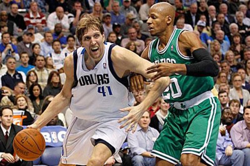 Dirk Nowitzki, left, drives on Boston Celtics guard Ray Allen during the first half of their NBA basketball game in Dallas.