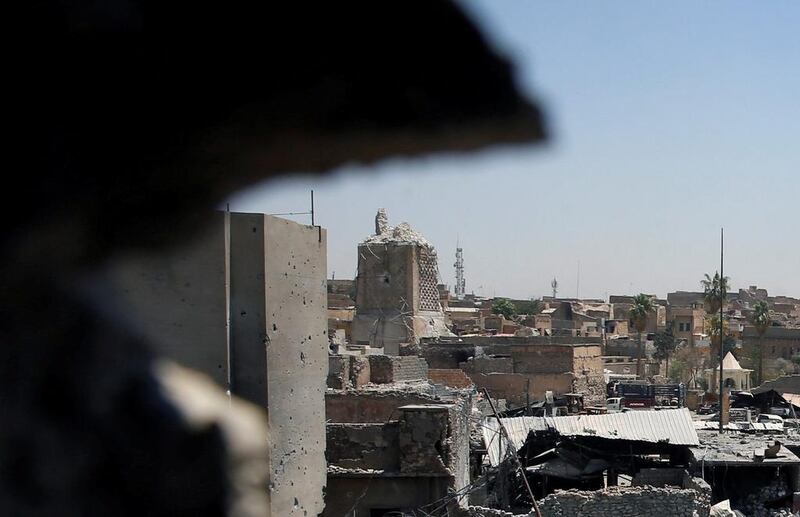 Above, the destroyed Al Hadba minaret at Grand Al Nuri mosque, left, as seen from an Iraqi-held position in Mosul, Iraq. Erik De Castro / Reuters