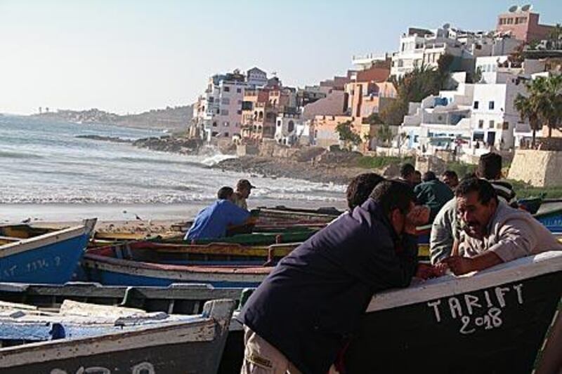 Fishermen enjoy a chat in the late afternoon on Taghazout beach, which attracts surfers from all over the world.