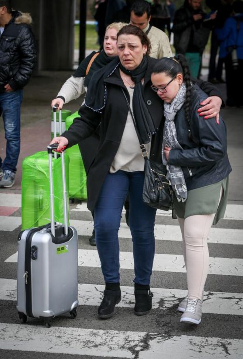 People are evacuated from Brussels Airport after at least 13 people were killed by two explosions in the departure hall of Brussels Airport. Virginie Lefour / AFP / Belga