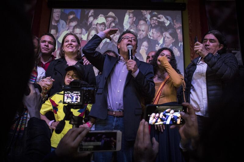 Gustavo Petro, presidential candidate for the Progressivists Movement Party, center, speaks during an election night event at the party's headquarters in Bogota, Colombia, on Sunday, May 27, 2018. Ivan Duque, an investor-friendly lawyer, whose campaign against a peace accord with Marxist guerrillas has divided Colombians, took first place in the country’s presidential election on Sunday. In a June 17 runoff he’ll face former guerrilla Petro, presenting voters with a stark choice. Photographer: Nicolo Filippo Rosso/Bloomberg