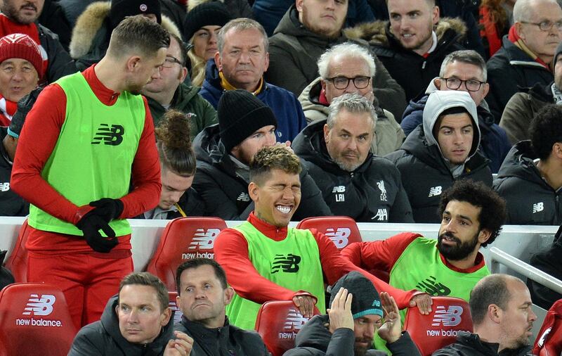 Jordan Henderson, Roberto Firmino and Mohamed Salah of Liverpool on the substitutes' bench during the Mersey derby against Everton. EPA