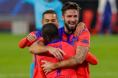 Chelsea's Olivier Giroud celebrates after scoring his side's third goal with teammates during the Champions League group E soccer match between Sevilla and Chelsea at the Ramon Sanchez Pijuan stadium in Seville, Spain, Wednesday, Dec. 2, 2020. (AP Photo/Angel Fernandez)