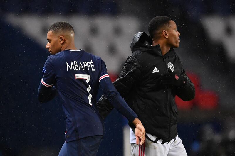 Kylian Mbappe shakes hands with Manchester United's French forward Anthony Martial. AFP