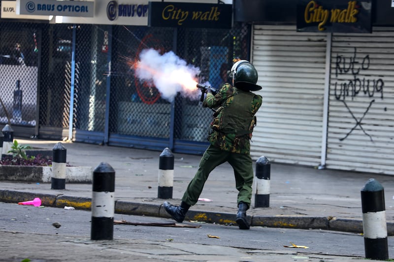 A police officer fires tear gas at demonstrators, many of whom fear the new law will exacerbate the cost-of-living crisis. EPA 