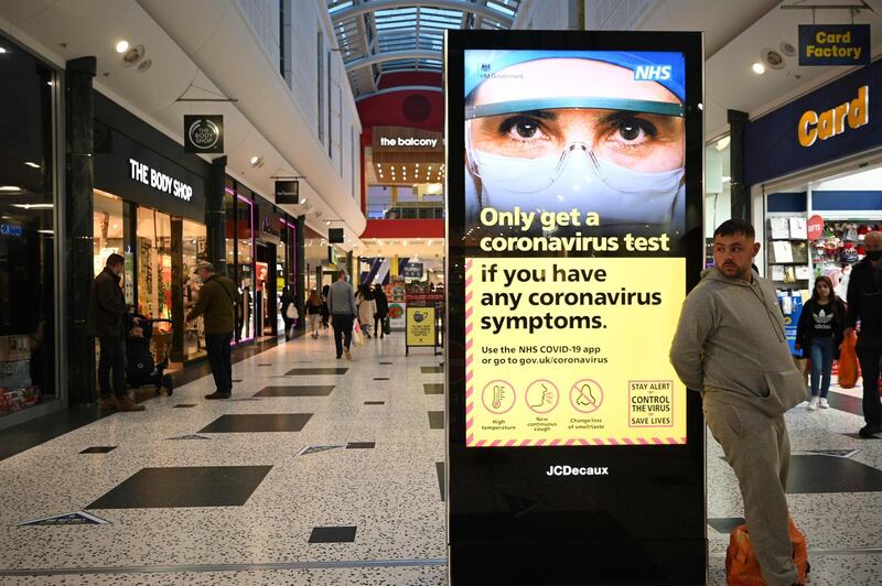An electronic billboard displays government messages in  a shopping centre in Leeds. AFP