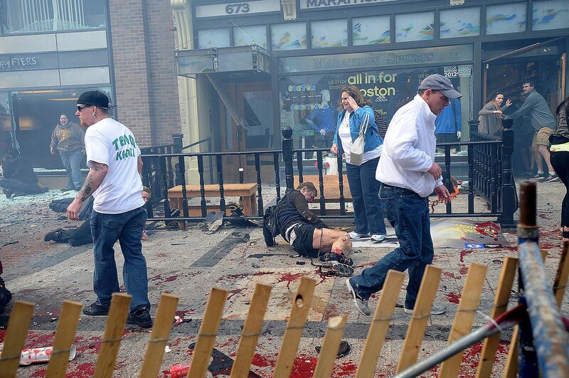 Injured people and debris lie on the sidewalk near the Boston Marathon finish line following an explosion in Boston, Monday, April 15, 2013. (AP Photo/MetroWest Daily News, Ken McGagh)  MANDATORY CREDIT *** Local Caption ***  APTOPIX Boston Marathon-Explosions.JPEG-08ff7.jpg