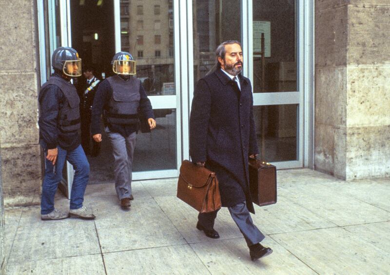 Italian judge Giovanni Falcone is escorted by police out of the Court of Palermo, Italy, on May 16, 1985. Giovanni Falcone was killed by the Mafia in 1992. (Photo by Vittoriano Rastelli/Corbis via Getty Images)