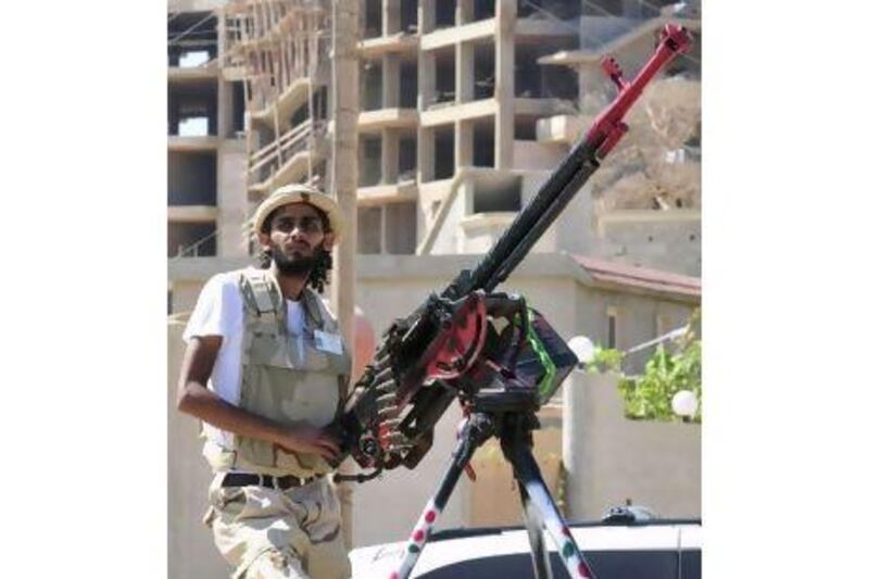 A rebel fighter mans a weapon near the Libyan National Transitional Council in Benghazi yesterday. The NTC faces a major crisis as its executive was sacked.