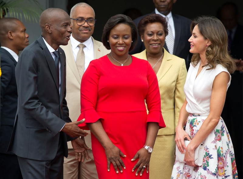 Haiti's President Jovenel Moise, left, and first lady Martine Moise, in red, receive Spain's Queen Letizia at the National Palace in Port-au-Prince on May 23, 2018.