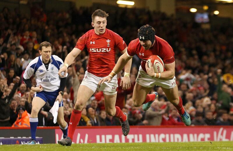 Wales' Leigh Halfpenny flies in to score his side's third try against Scotland, during their Six Nations rugby match at the Principality Stadium in Cardiff, Wales, Saturday Feb. 3, 2018. (Paul Harding/PA via AP)