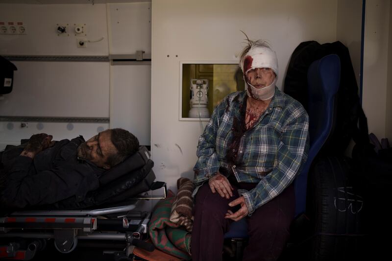 Injured civilians sit in an ambulance before being taken to a hospital after a Russian attack in Kharkiv, Ukraine. AP