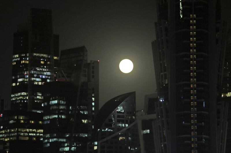 The supermoon rises over the city skyline in Dubai. Kamran Jebreili / AP Photo