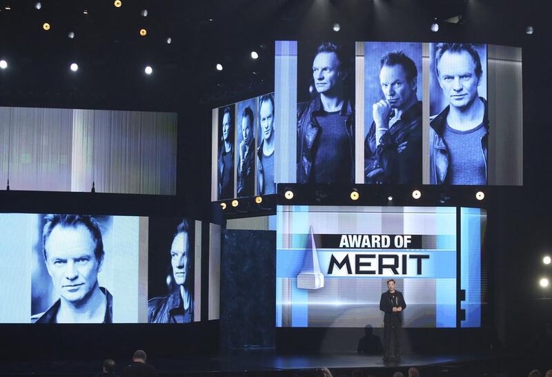 Robert Downey Jr presents the award of merit to Sting at the American Music Awards at the Microsoft Theater. Matt Sayles / Invision / AP
