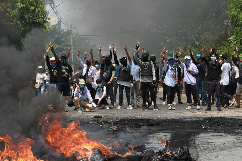 Protesters gesture with a three-finger salute in Thaketa township Yangon. AP Photo