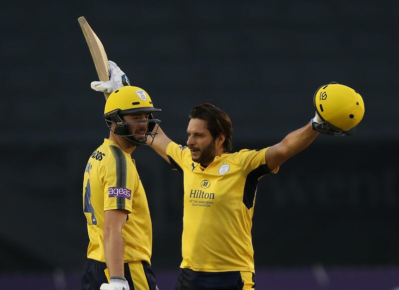 DERBY, ENGLAND - AUGUST 22:   Shahid Afridi (R) of Hampshire celebrates his century with James Vince during the NatWest T20 Blast at The 3aaa County Ground on August 22, 2017 in Derby, England. (Photo by Nigel Roddis/Getty Images)