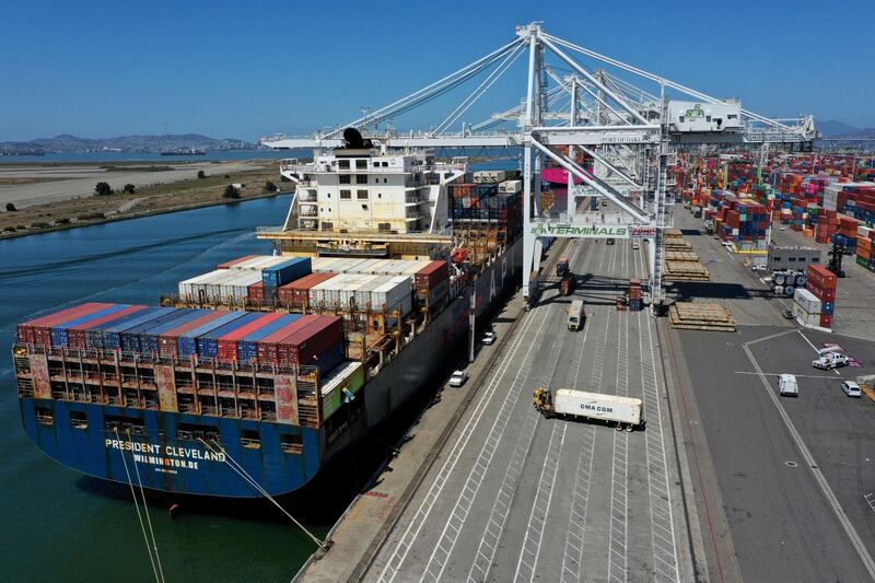 OAKLAND, CALIFORNIA - MAY 07: In an aerial view, an container ship is unloaded at the Port of Oakland on May 07, 2021 in Oakland, California. The Port of Oakland reported a record high in cargo traffic volume between January and March of this year with 631,119 20-foot shipping containers compared to 612,151 set in the first quarter of 2019.   Justin Sullivan/Getty Images/AFP
== FOR NEWSPAPERS, INTERNET, TELCOS & TELEVISION USE ONLY ==
