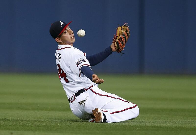 Daniel Castro #14 of the Atlanta Braves bobbles the pop fly of Mookie Betts #50 of the Boston Red Sox as he catches it for the out during the fourth inning of a baseball game at Turner Field in Atlanta, Georgia.  Butch Dill / Getty Images / AFP