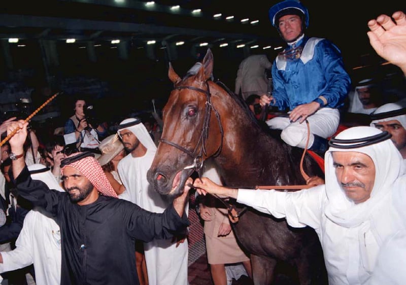 Sheikh Hamdan bin Rashid, right, and Sheikh Mohammed bin Rashid lead Sheikh Hamdan's winning horse Almukawatel around the racecourse after it and British jockey Richard Hills won a surprise victory at the 1999 Dubai World Cup. Reuters