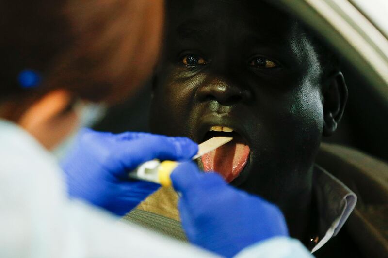 A man undergoes a swab test at a drive-through Covid-19 testing facility at the Melbourne Showgrounds in Melbourne, Australia.  EPA