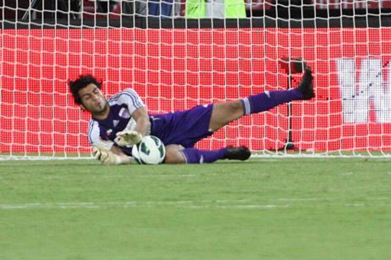 Al Ain goalkeeper Dawoud Sulaiman stops an Al Jazira penalty as he inspires his side to Super Cup victory