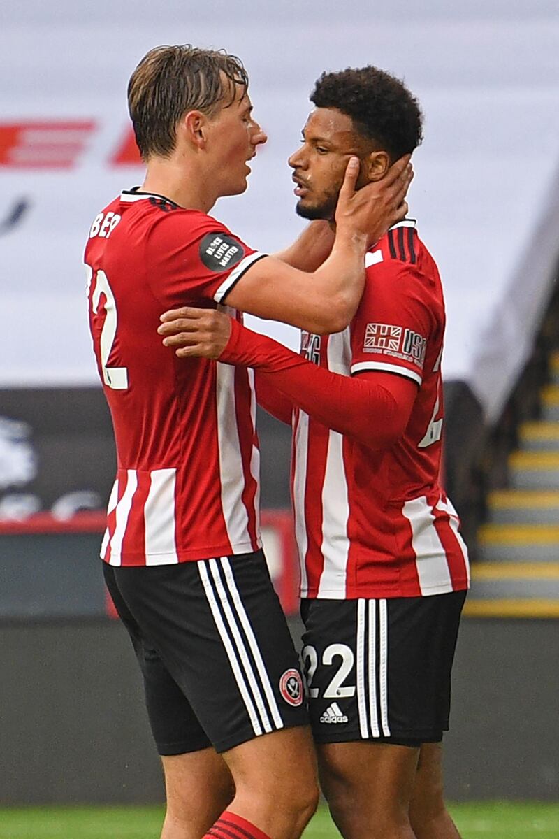 First goal-scorer Sheffield United's Norwegian midfielder Sander Berge (L) congratulates Sheffield United's French striker Lys Mousset (R) after he scores their second goal during the English Premier League football match between Sheffield United and Tottenham Hotspur at Bramall Lane in Sheffield, northern England on July 2, 2020. RESTRICTED TO EDITORIAL USE. No use with unauthorized audio, video, data, fixture lists, club/league logos or 'live' services. Online in-match use limited to 120 images. An additional 40 images may be used in extra time. No video emulation. Social media in-match use limited to 120 images. An additional 40 images may be used in extra time. No use in betting publications, games or single club/league/player publications.
 / AFP / POOL / Oli SCARFF / RESTRICTED TO EDITORIAL USE. No use with unauthorized audio, video, data, fixture lists, club/league logos or 'live' services. Online in-match use limited to 120 images. An additional 40 images may be used in extra time. No video emulation. Social media in-match use limited to 120 images. An additional 40 images may be used in extra time. No use in betting publications, games or single club/league/player publications.
