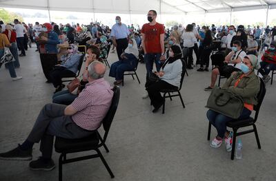 epa09229229 People wait to receive a shot of the COVID-19 vaccine at a mass immunization venue inside Cairo's International Exhibition Center, in Cairo, Egypt, 26 May 2021.  EPA/KHALED ELFIQI