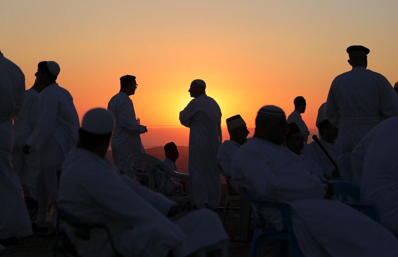 Samaritans stand praying on top of Mount Gerizim near the northern West Bank city of Nablus as they celebrate the Shavuot festival at dawn. AFP