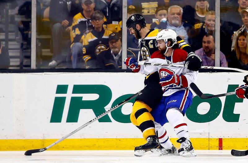Montreal’s David Desharnais, right, gets physical with the taller Zdeno Chara of Boston. Jared Wickerham / AFP


