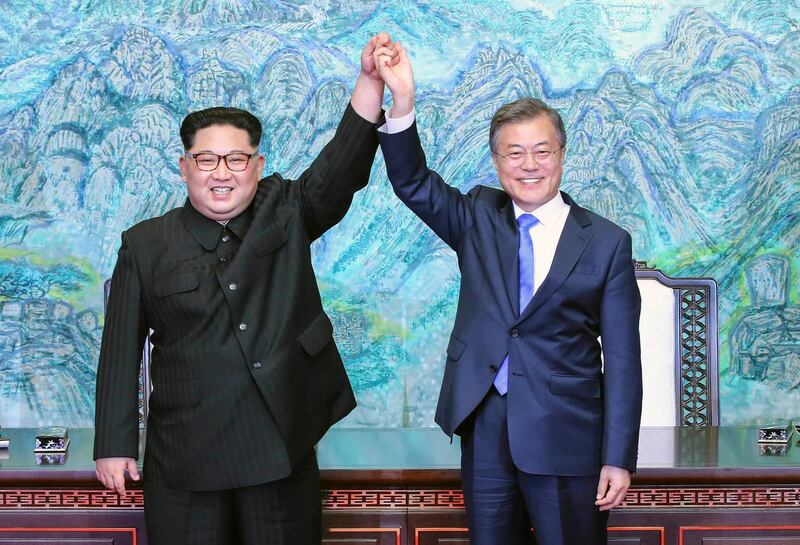 File-This April 27, 2018, file photo shows North Korean leader Kim Jong Un, left, and South Korean President Moon Jae-in raising their hands after signing a joint statement at the border village of Panmunjom in the Demilitarized Zone, South Korea. North Korea readjusted its time zone to match South Koreaâ€™s on Saturday and described the change as an early step toward making the longtime rivals â€œbecome oneâ€ following a landmark summit. North Korean leader Kim Jong Un promised to sync his countryâ€™s time zone with the Southâ€™s during his April 27 talks with South Korean President Moon Jae-in. A dispatch from the Northâ€™s Korean Central News Agency says that promise was fulfilled Saturday by a decree of the nationâ€™s Presidium of the Supreme People's Assembly. (Korea Summit Press Pool via AP, File)
