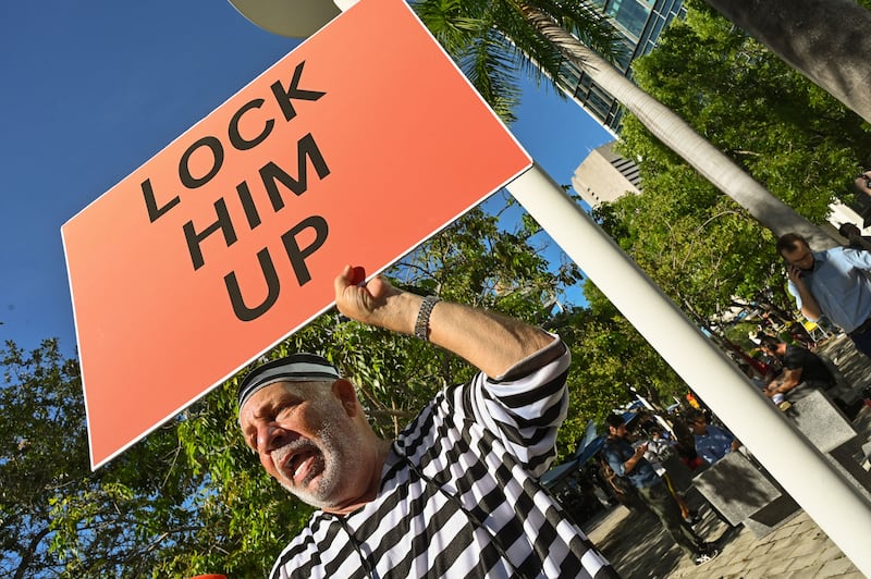 A man protests outside a Miami, Florida, federal courthouse on June 13 as former president Donald Trump is arraigned on dozens of charges related to his handling of classified information. AFP