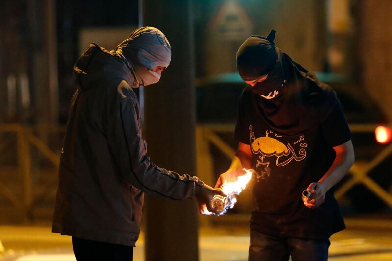 Palestinian protesters light a Molotov cocktail petrol bomb during confrontations with Israeli forces in the Shuafat camp for Palestinian refugees, in Israeli-annexed East Jerusalem. AFP