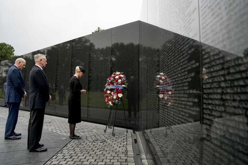 Cindy McCain, wife of, Sen. John McCain, accompanied by White House chief of staff John Kelly, left, and defence secretary Jim Mattis, second from left, lays a wreath at the Vietnam Veterans Memorial in Washington. AP