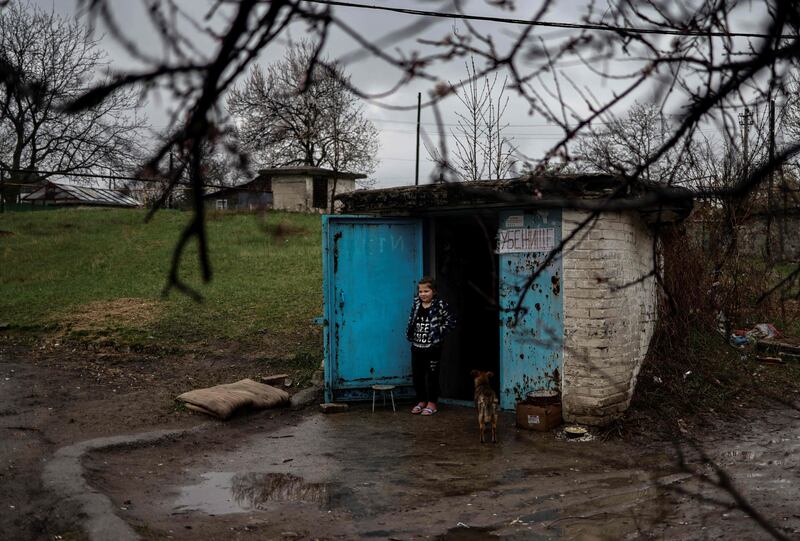 A girl stands by the door of a bunker in Severodonetsk, in eastern Ukraine's Donbas region, as Russian troops intensify a campaign to take the strategic port city of Mariupol. AFP