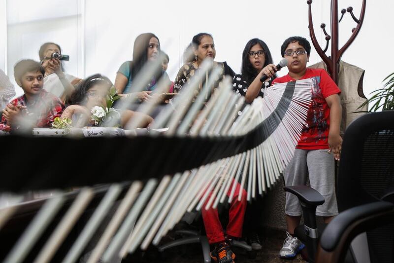 Vivesh Sheshan explains his project that demostrates the movement of waves. A group of school children created science projects based on waste and met to display their ideas and creations at Jumeirah Lake Towers. Antonie Robertson / The National 