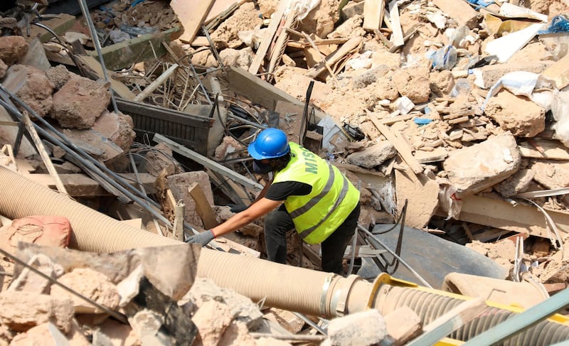 FILE PHOTO: A volunteer digs through the rubble of buildings which collapsed due to the explosion at the port area, after signs of life were detected, in Gemmayze, Beirut, Lebanon September 5, 2020. REUTERS/Mohamed Azakir/File Photo