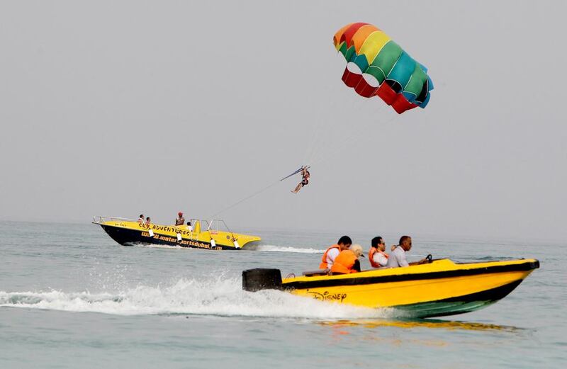 An Iranian parasails as others ride a speed boat by Kish Island.  AFP