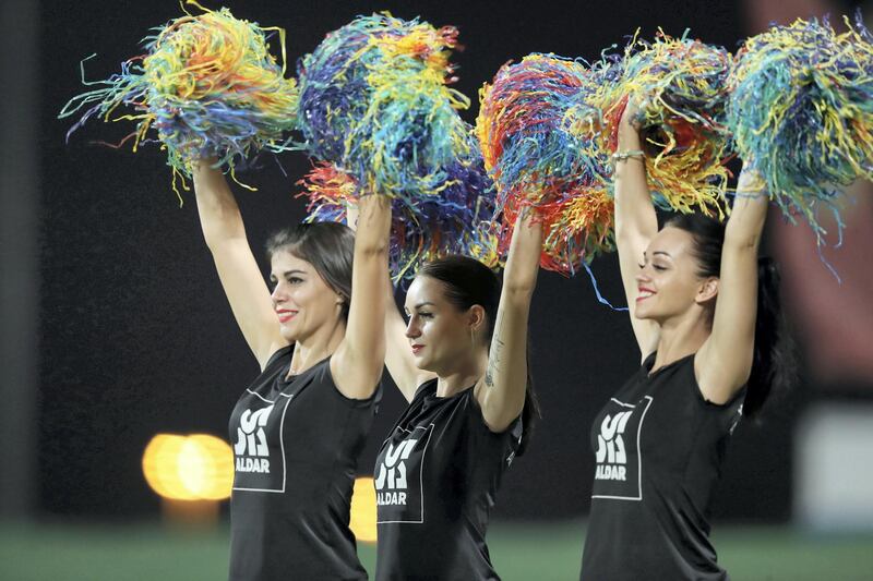 Abu Dhabi, United Arab Emirates - November 18, 2019: Cheerleaders wave pompoms during the game between Maratha Arabians and Team Abu Dhabi in the Abu Dhabi T10 league. Monday the 18th of November 2019. Zayed Cricket Stadium, Abu Dhabi. Chris Whiteoak / The National