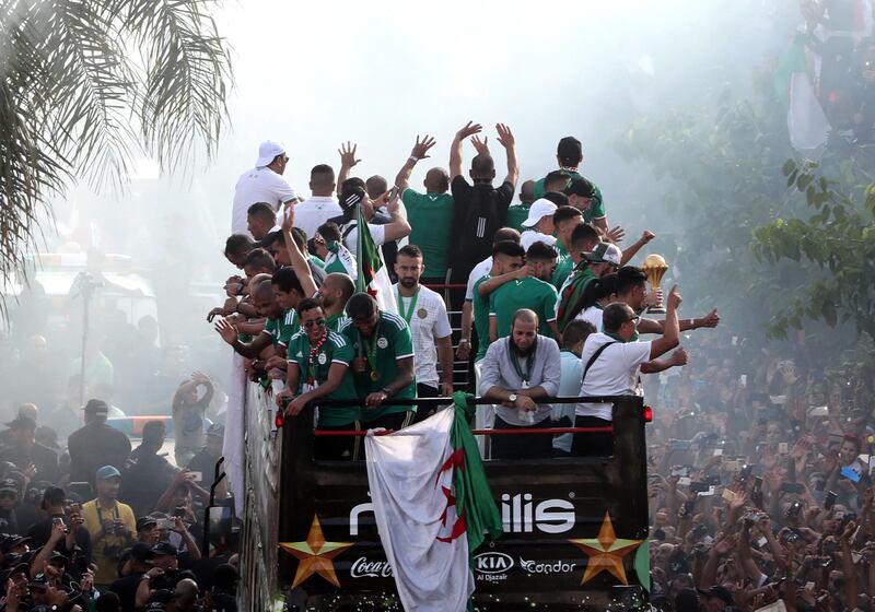 The Algerian players were driven through the streets of Algiers in a bus. EPA