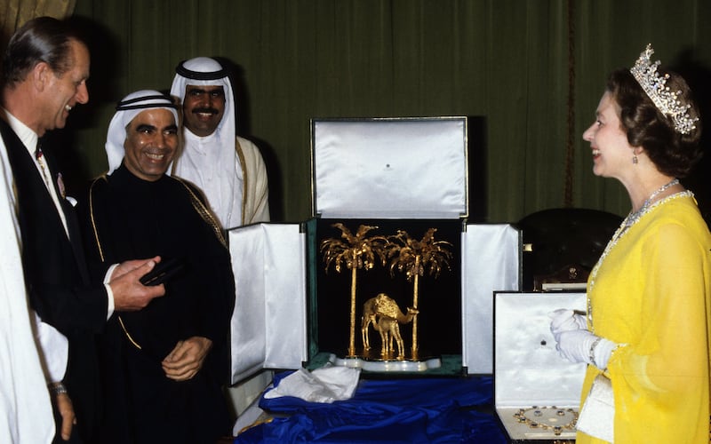 The Queen is presented with gifts,  including a solid gold sculpture of a camel and its calf from Sheikh Rashid bin Saeed, Ruler of Dubai, during her Gulf visit in February 1979. Getty